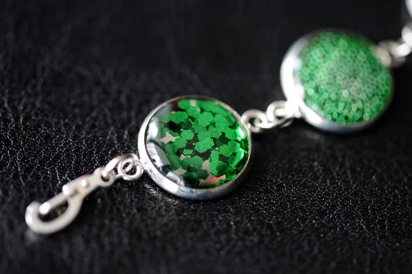 Green resin bracelet on a dark background close up