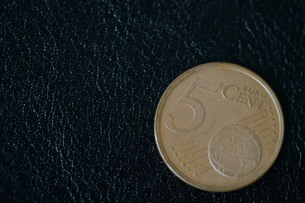 Coin in five euro cents on a dark background close up