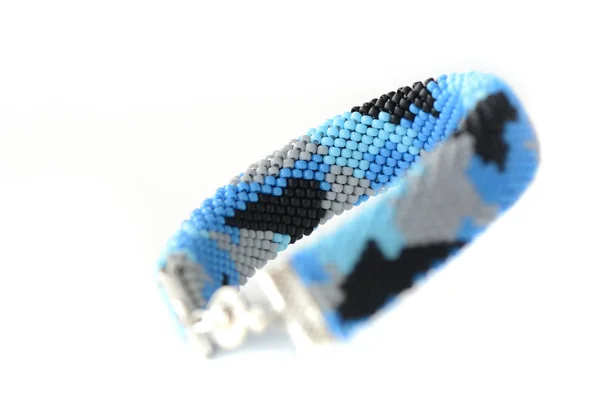 Navy blue camouflage bracelet isolated on white background close up