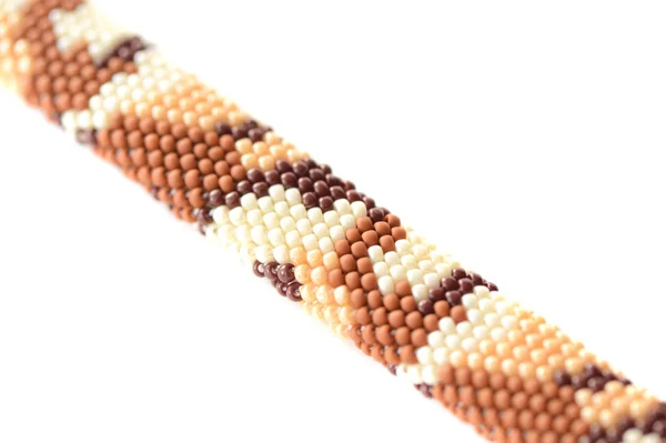 Desert camouflage beaded bracelet isolated on white background close up
