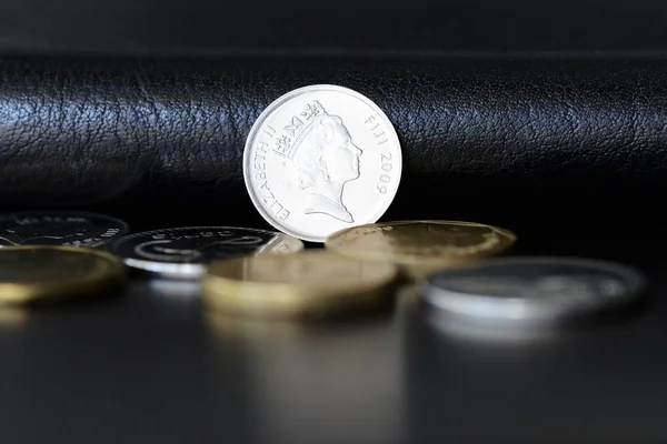 Five fijian cents on a dark background close up