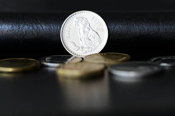 Twenty fijian cents on a dark background close up