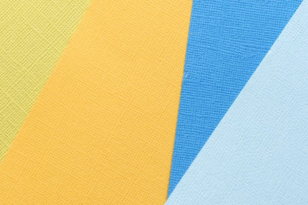 Blue and yellow abstract paper background. Paper texture close up
