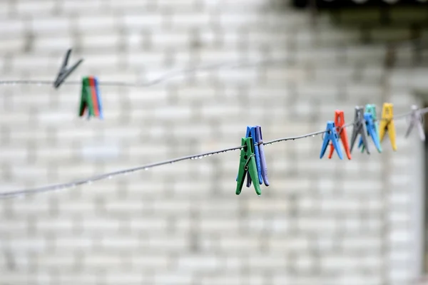 Plastic clotheslines with water drops after rain close up