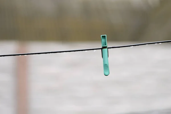 Plastic clothesline with water drops after rain close up