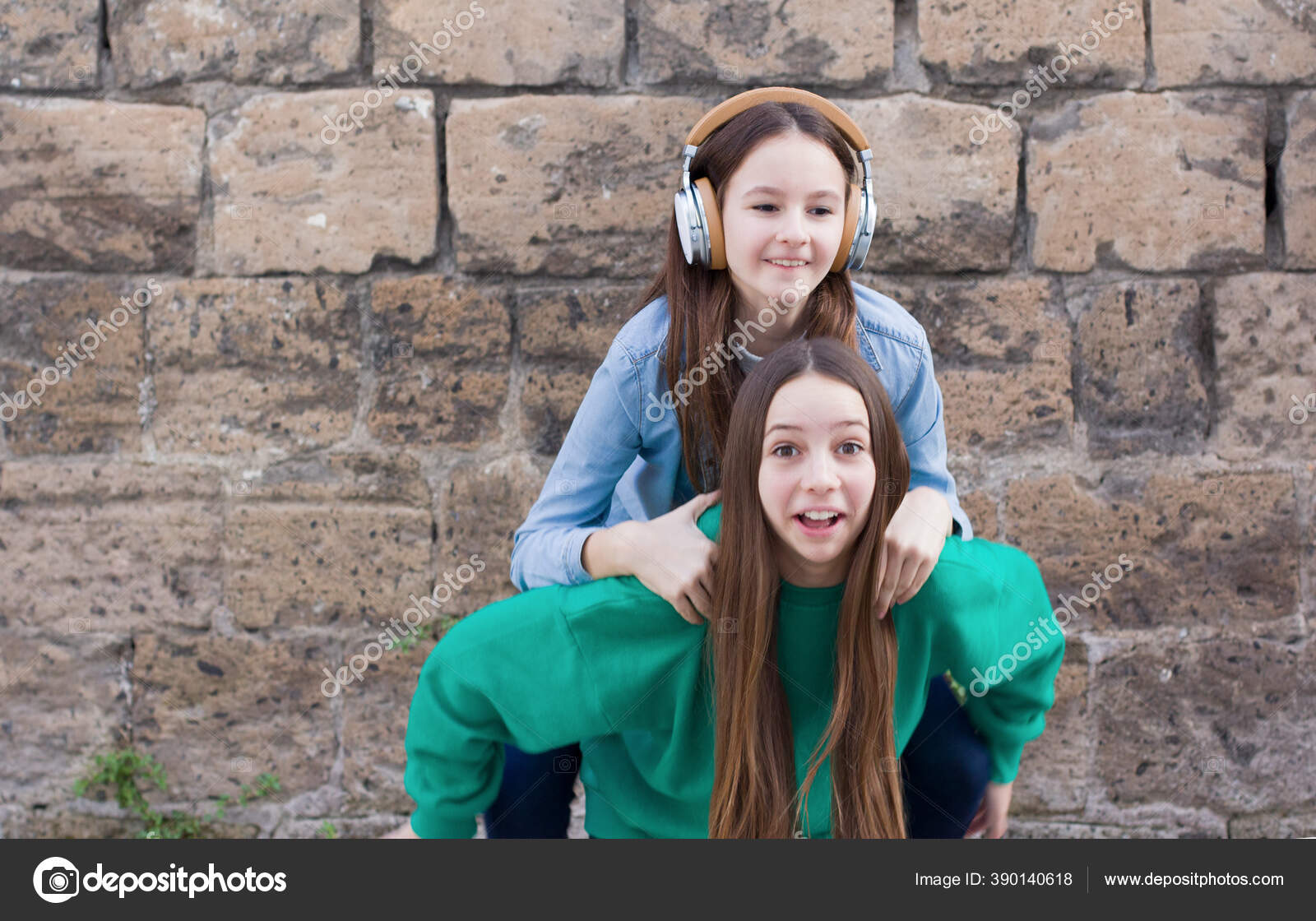 Teen Girls Have Fun Old Brick Wall Background Stock Photo by ©Natiss