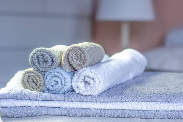 Stack of bath towels on bed decoration in bedroom interior