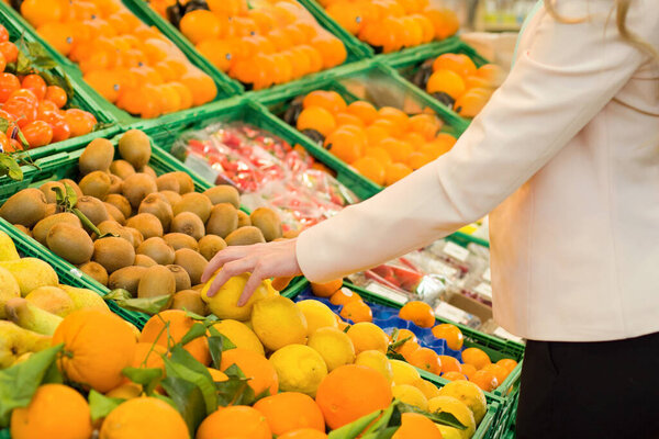 Female hand choosing vegetables in the store
