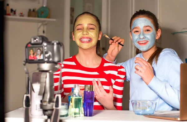 Two Teenager bloggers test beauty products for their followers and tell their impressions, opinions. Teenagers\' communication concept, virtual and digital community that grows every day.