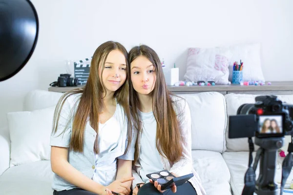 Two beauty bloggers present jokes and have fun broadcasting live videos on social networks. Focus on teen girls influencer bloggers. Beauty bloggers and vlog concept.