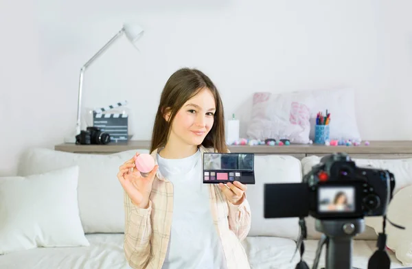 Teen blogger presenting beauty products and broadcasting live videos on social networks. Focus on teen girls influencer bloggers. Beauty bloggers and vlog concept.