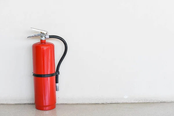 Fire extinguisher tank on the background wall.