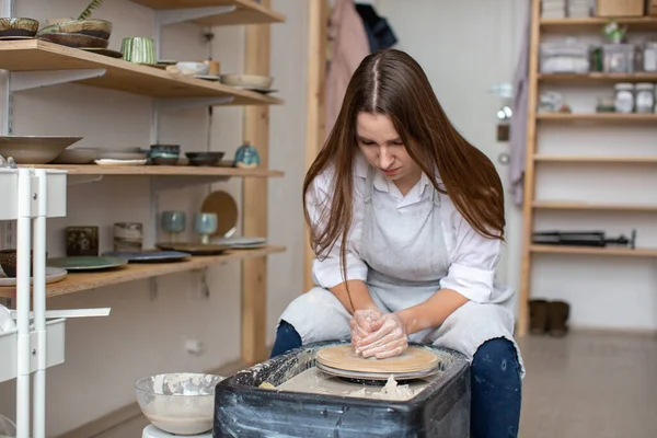 Samica garncarki produkuje naczynia ceramiczne z gliny w garncarni. — Zdjęcie stockowe