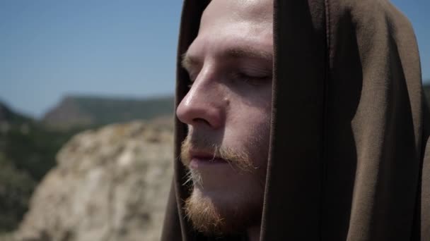 The face of a man with a hood close-up with a brooding look — Stock Video