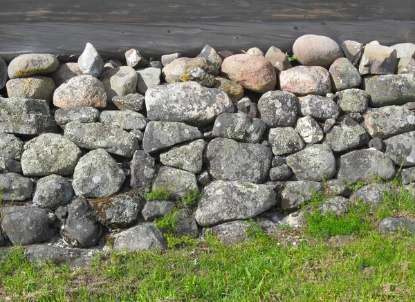 Ancient Foundation for a wooden house of large granite stones of different shapes and sizes.