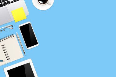dizüstü bilgisayar, ofis malzemeleri, kahve fincanı, cep telefonu ve mavi pastel arka plan üzerinde kahve fincanı ile çalışma alanı tablo