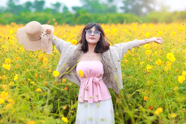 Kozmos çiçek alanı arasında doğada açık havada duran şapka ile sevimli ve güzel kız (tatil kavramı dinlenme zamanı) — Stok fotoğraf