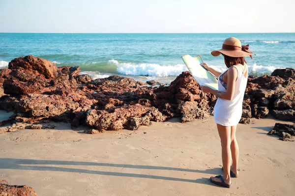 Retrato de bela mulher viajante olhando e verificando mapa na praia da ilha — Fotografia de Stock