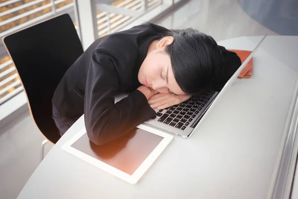 lazy businesswomen sleeping on laptop computer