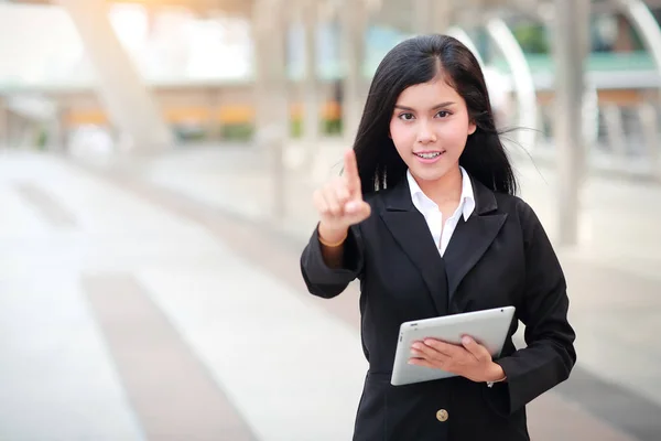 businesswoman using tablet and pointing fingure