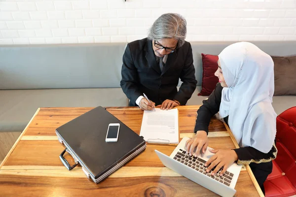 Incontro uomo d'affari musulmano e discussione con la donna d'affari utilizzando il computer portatile e la firma del contratto — Foto Stock