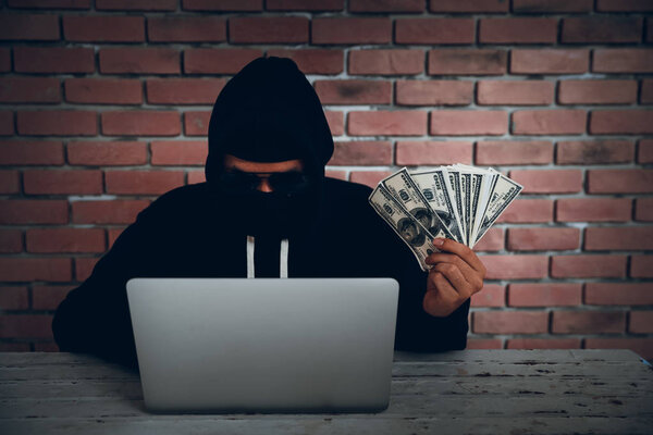 hacker try to hack and steal information system data from computer and show money after hacked it