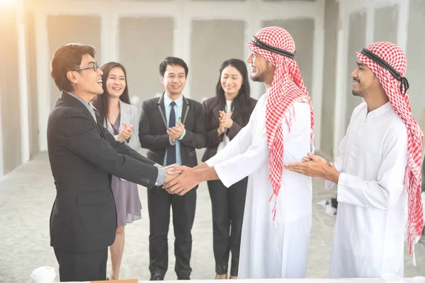 Arab Saudi affärsman skakar hand med företagare för framgångsrik affär med som affärsbakgrund (begreppet teamwork och partnerskap — Stockfoto