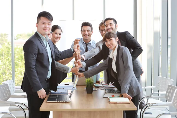 success business deal with stacking hands of business people (teamwork or partnership concept)