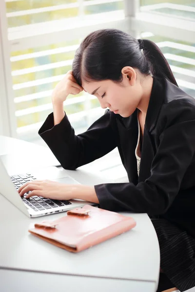 lazy businesswomen sleeping on laptop computer