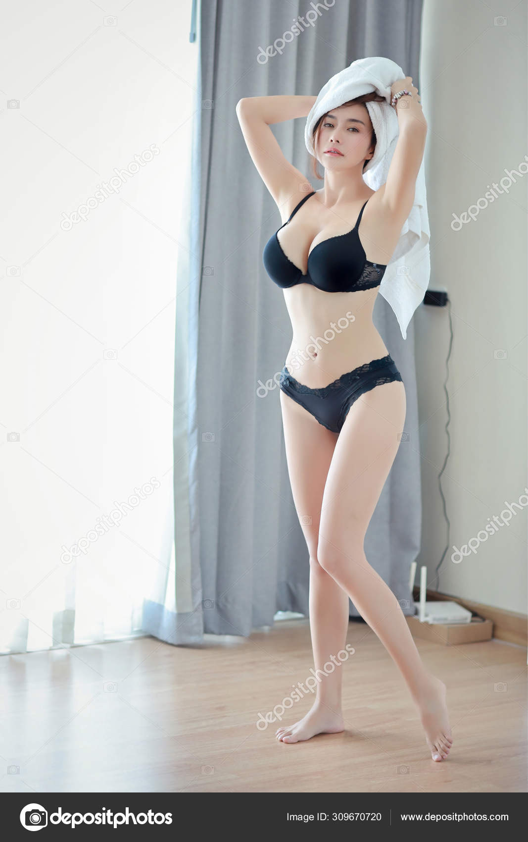 Full length sexy pose shot of beautiful asian woman who wearing white towel  and black lingerie and standing in bedroom, preparing for morning shower  Stock Photo by ©Parkpoom 309670720