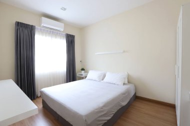 beyaz yatak ve yumuşak berrak pencere ışığı ile yeni modern inci ve beyaz yatak odası yan görünümü