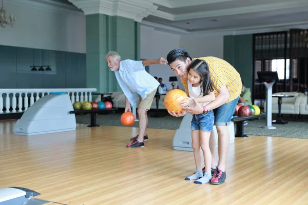 full shot of happy asian young single dad teaching daughter how