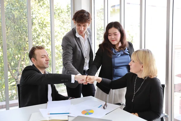 success business deal with doing fist bump of business people (teamwork or partnership concept)