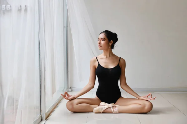 beautiful healthy asian woman in ballet dress enjoying in meditates with yoga pose at home with relaxation