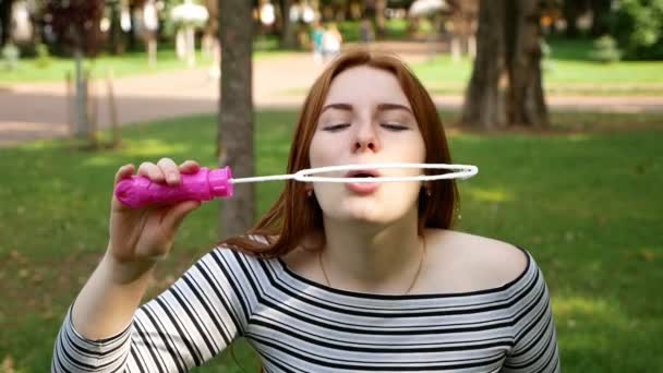 Red Haired Girl Blows Soap Bubbles Park She Smiling Laughing — Stock Video