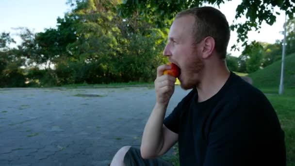 Guy Eats Fruit Summer Park — Stock Video