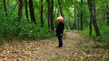 Sonbahar ormanında Halloween kabak baş yüzleri bir zombi gibi hareket