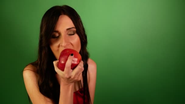 Closeup Brunette Woman Eagerly Eating Red Apple Green Background — Stock Video