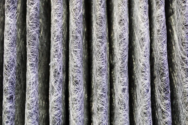 Antibacterial filter of a modern car air conditioner. Macro. The structure of the filter material.