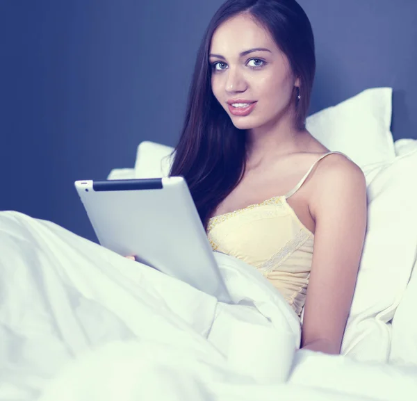 Vrouwen gebruiken een tablet pc op het bed — Stockfoto