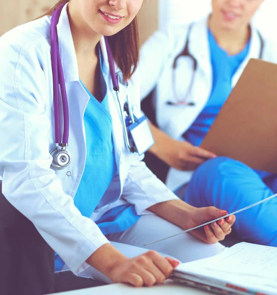 Twee jonge vrouwelijke dokters zitten op de bank — Stockfoto