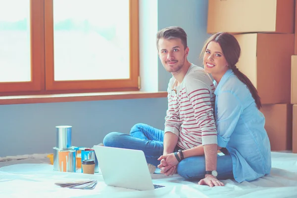 Young couple sitting on the floor of their new apartment. Young couple — Stock Photo, Image
