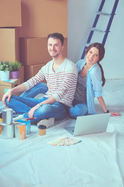 Young couple sitting on the floor of their new apartment. Young couple — Stock Photo, Image