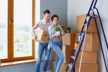 Mutlu genç çift açma veya kutu ambalaj ve yeni evine taşıdıktan.