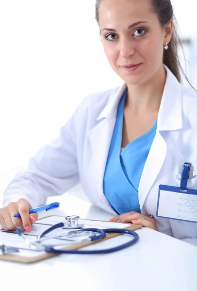 Porträt einer jungen Ärztin, die im Krankenhaus am Schreibtisch sitzt. Ärztin. — Stockfoto
