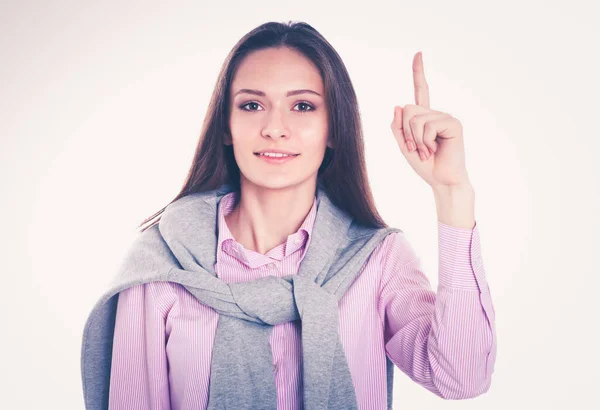 Portrait of a happy young woman pointing up isolated on white next to copyspace — Stock Photo, Image