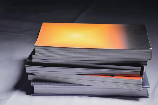 Close-up of several colored books stacked on a placed on top selective focus and shallow depth of field — Stock Photo, Image