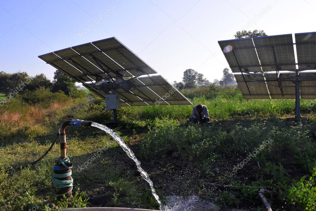 agricultural equipment for field irrigation, water jet, behind which is solar panel's,