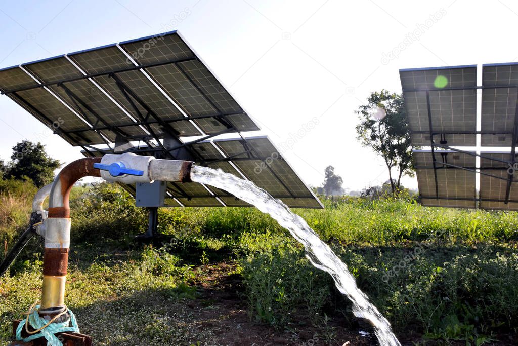 agricultural equipment for field irrigation, water jet, behind which is solar panel's,