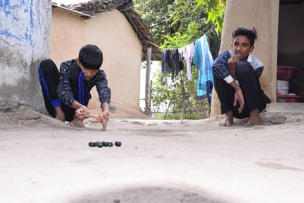 India, Indian children playing marbles in the village, Beautiful view of rural sports